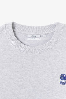 Gem&ecirc;leerde sweater ronde hals, borduursel borst