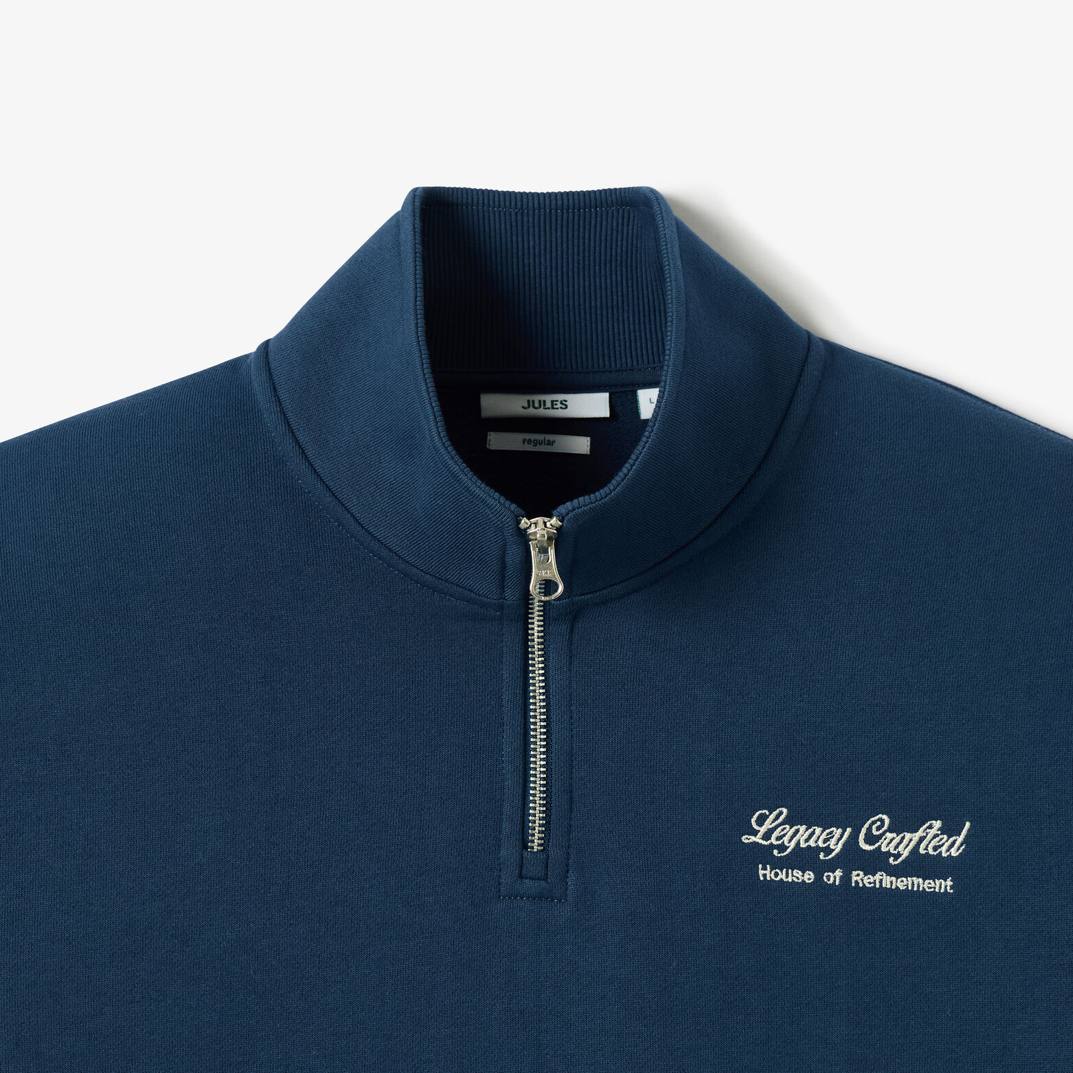 Sweater met ritskraag, geborduurd "Legacy crafted"